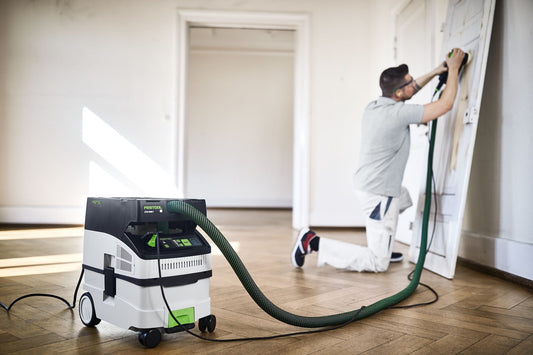 Festool CTM MIDI I Absaugmobil mit Schlauch beim Schleifen an Wand, kompakte Bauform mit Rädern, Staubklasse M