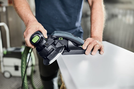 Festool ES-ETS 125 REQ-Plus Kantenschleifer in Anwendung beim Schleifen einer Holzkante mit grünem Absaugschlauch